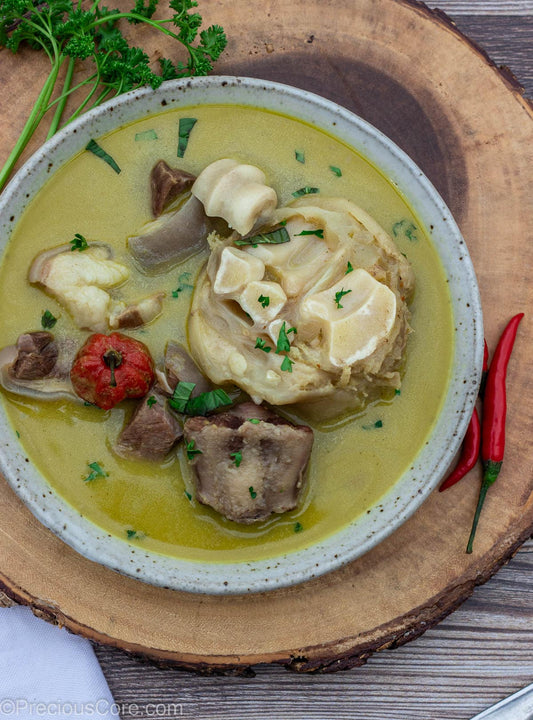 Aromatic hot broth pepper soup with herbs and meat, ready to serve