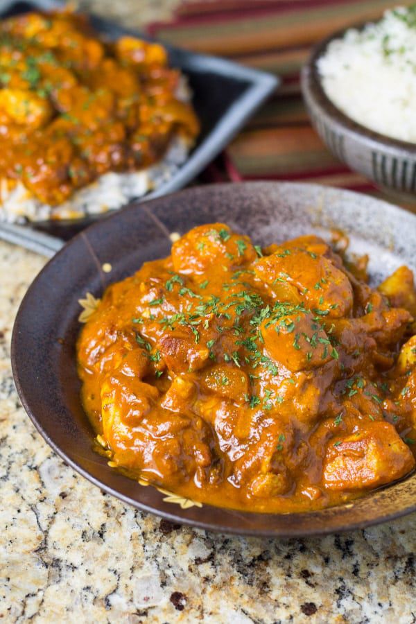 A slow cooker one-pot chicken dish in a bowl, deeply seasoned and ready to serve